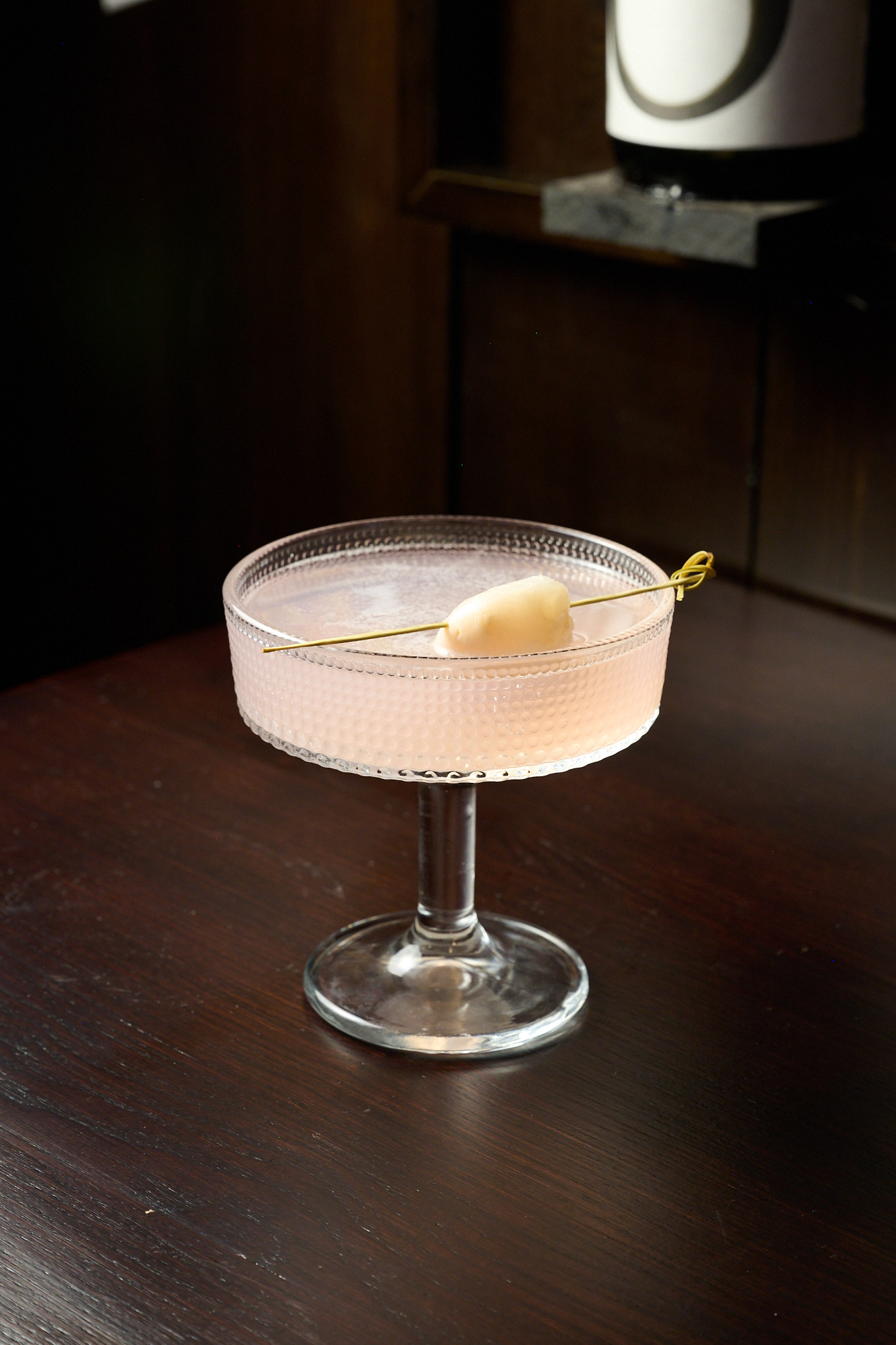 Elegant pink sake cocktail served in a crystal coupe glass at Showa Era Izakaya Manhattan