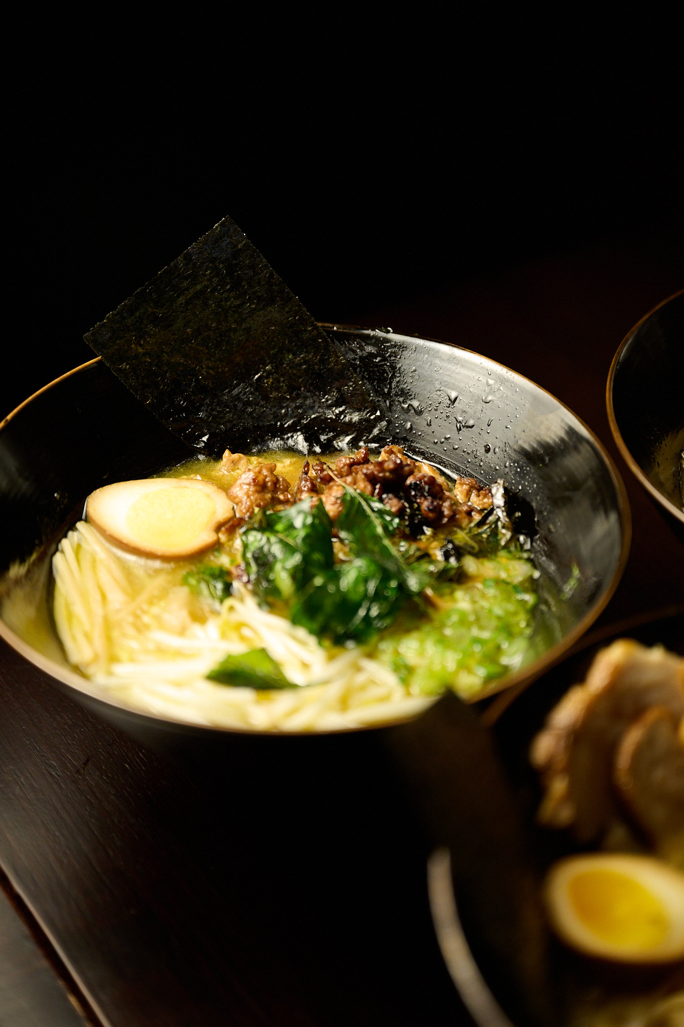 Steaming tonkotsu ramen with chashu pork, soft egg, nori and bean sprouts at Showa Era Izakaya