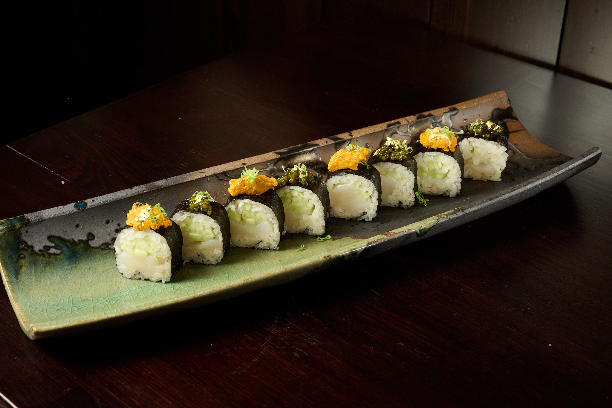 Premium uni and scallop maki roll with caviar on artisan ceramic plate at Showa Era Izakaya NYC