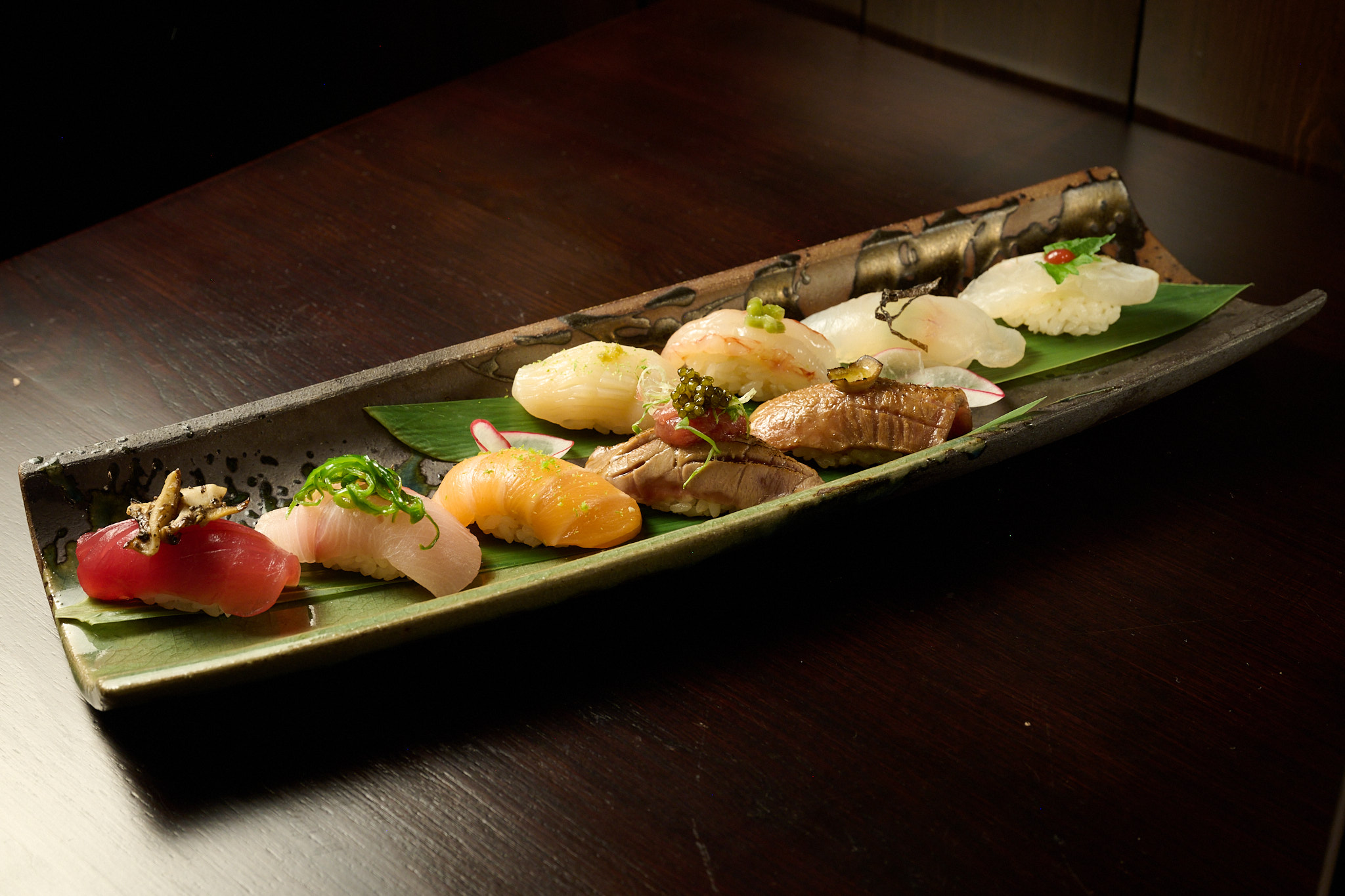 Omakase nigiri boat with tuna, salmon, shrimp and hamachi on banana leaf at NYC izakaya