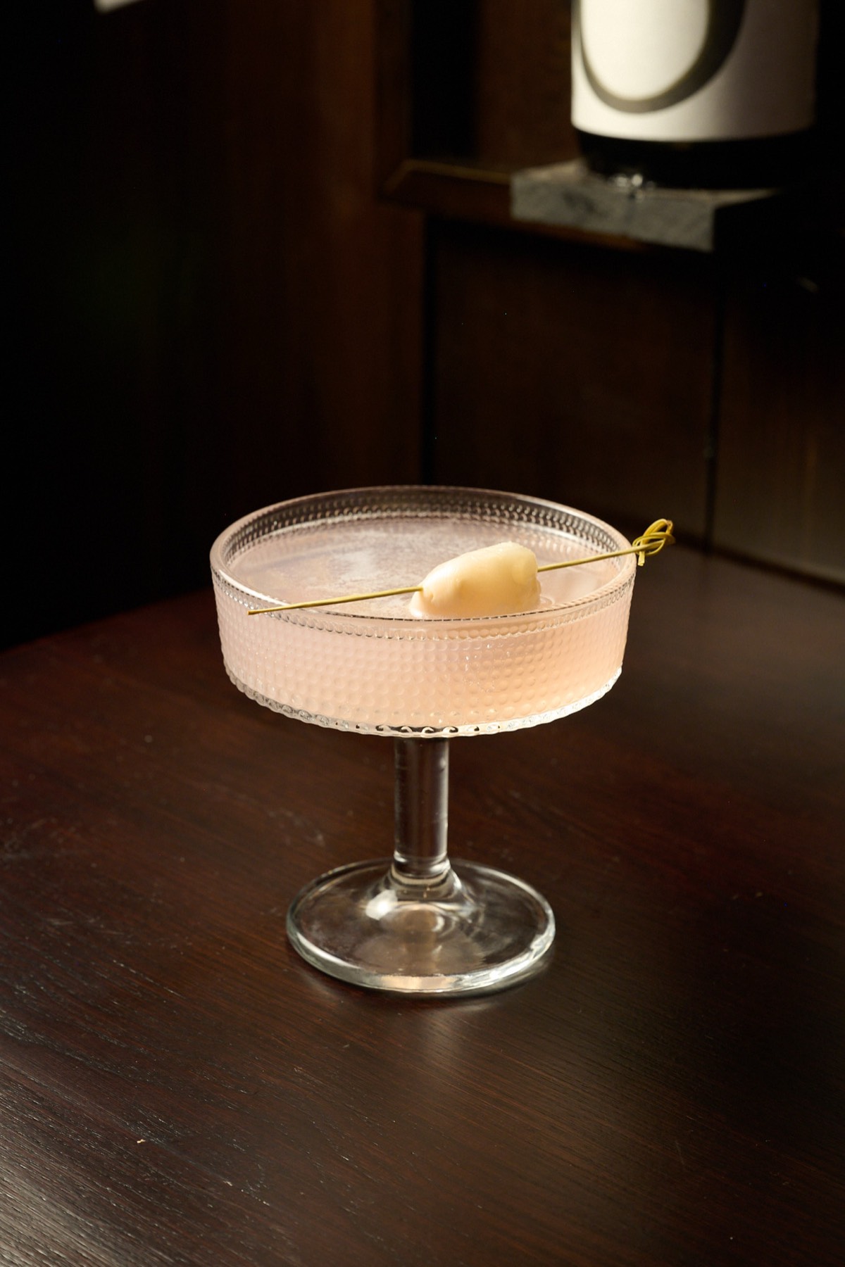 Elegant Japanese lychee cocktail in coupe glass at Showa Era sake bar NYC